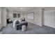 Cozy living room area with comfortable seating and a screen at 9876 Magnus Ct, Las Vegas, NV 89178
