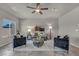 Bright living room with tile flooring, ceiling fan, stylish furniture, and natural lighting at 9876 Magnus Ct, Las Vegas, NV 89178