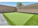 Backyard with beautiful putting green and well-maintained landscaping at 9876 Magnus Ct, Las Vegas, NV 89178