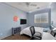 Cozy bedroom with blue walls, a window with blinds, and a ceiling fan at 10212 Cider Mill Rd, Las Vegas, NV 89135
