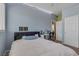 Bedroom featuring blue walls, plush carpeting, and a ceiling fan at 10212 Cider Mill Rd, Las Vegas, NV 89135