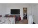 Bedroom featuring a TV, floral bedding, and entry to another room at 10212 Cider Mill Rd, Las Vegas, NV 89135