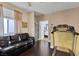 Bonus room featuring wood floors, a ceiling fan, and a leather sofa at 10212 Cider Mill Rd, Las Vegas, NV 89135