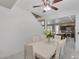 Bright dining area featuring a large white table, seating for six, and a clear view to the kitchen at 10212 Cider Mill Rd, Las Vegas, NV 89135