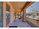 Covered front porch with stone pillars offering a relaxing view of the neighborhood at 10212 Cider Mill Rd, Las Vegas, NV 89135