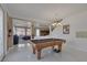 Elegant game room featuring a pool table, stylish decor, and access to additional living spaces at 10212 Cider Mill Rd, Las Vegas, NV 89135