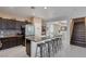 Modern kitchen with an island, bar seating, and seamless access to a bright dining area at 10212 Cider Mill Rd, Las Vegas, NV 89135