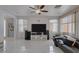 Spacious living room with tile floors, a ceiling fan, and a comfortable seating area at 10212 Cider Mill Rd, Las Vegas, NV 89135