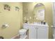 Charming bathroom features a mirrored sink, toilet and wooden-look floors at 1105 Declaration Dr, Las Vegas, NV 89110