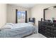 Bedroom featuring window with dark curtains, dresser and light-colored walls at 1105 Declaration Dr, Las Vegas, NV 89110