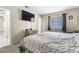 A cozy bedroom with a TV, window, and dresser, perfect for relaxation at 1105 Declaration Dr, Las Vegas, NV 89110