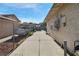 Extended driveway alongside the home, ideal for extra parking, enclosed by a chain link fence for added security at 1105 Declaration Dr, Las Vegas, NV 89110