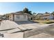 Charming single-story home featuring a spacious driveway and well-maintained front yard under a clear blue sky at 1105 Declaration Dr, Las Vegas, NV 89110