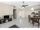 Bright living room with tiled flooring, a ceiling fan, and access to the kitchen and front door at 1105 Declaration Dr, Las Vegas, NV 89110
