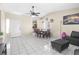 Living room featuring tile flooring, a ceiling fan, dining table and access to backyard and kitchen at 1105 Declaration Dr, Las Vegas, NV 89110