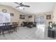 Spacious living room with tile flooring, ceiling fan, and sliding glass door to backyard at 1105 Declaration Dr, Las Vegas, NV 89110