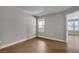 Bright bedroom with hardwood floors, a large window, and a neutral color scheme creates a serene and inviting atmosphere at 1150 N Buffalo Dr # 2025, Las Vegas, NV 89128