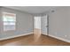 Bright bedroom with hardwood floors, a large window, and a neutral color scheme creates a serene and inviting atmosphere at 1150 N Buffalo Dr # 2025, Las Vegas, NV 89128
