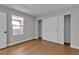 Bright bedroom featuring wood floors, a window, and a closet with sliding doors at 1150 N Buffalo Dr # 2025, Las Vegas, NV 89128