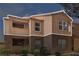 Multi-story apartment building with private balcony, lush landscaping, and tile roof at 1150 N Buffalo Dr # 2025, Las Vegas, NV 89128