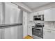 Well-equipped kitchen featuring stainless steel appliances, and modern white cabinetry at 1150 N Buffalo Dr # 2025, Las Vegas, NV 89128