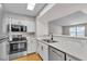 Updated kitchen featuring stainless steel appliances and stone countertops at 1150 N Buffalo Dr # 2025, Las Vegas, NV 89128