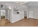 Bright and airy living room featuring modern lighting, wood floors, and views to the kitchen and bathroom at 1150 N Buffalo Dr # 2025, Las Vegas, NV 89128