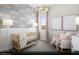 Cozy Bedroom featuring a crib with serene wallpaper and natural lighting that makes for a calm and relaxing space at 121 Piano Ln # Lot 198, Henderson, NV 89015