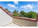 Balcony view of trees, blue sky and houses in the neighborhood at 13 Dovetail Cir, Henderson, NV 89014