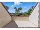 Tiled balcony featuring a view of palm trees and a building in the distance at 13 Dovetail Cir, Henderson, NV 89014