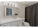 Bathroom featuring a vanity with a granite countertop and a shower with a tile surround at 13 Dovetail Cir, Henderson, NV 89014