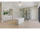 A bright bathroom features a freestanding tub, frameless shower, dual sink vanity, and modern lighting at 13 Dovetail Cir, Henderson, NV 89014