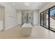This modern bathroom features a freestanding tub, walk-in shower, and sliding glass door for natural light at 13 Dovetail Cir, Henderson, NV 89014