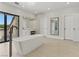 This luxury bathroom features a freestanding tub, access to a private patio, and a modern vanity at 13 Dovetail Cir, Henderson, NV 89014