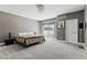 This bedroom features neutral walls and carpet, with a queen bed and stylish decor at 13 Dovetail Cir, Henderson, NV 89014