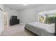 Spacious bedroom featuring a walk-in closet and large window overlooking the landscaped yard at 13 Dovetail Cir, Henderson, NV 89014