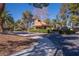 Quail Ridge Estates entrance with desert landscaping, mature trees, and covered guard house at 13 Dovetail Cir, Henderson, NV 89014