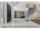 Modern foyer with grand staircase, soaring ceilings, and expansive windows offering plenty of natural light at 13 Dovetail Cir, Henderson, NV 89014