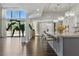 Bright open kitchen area with granite countertops, seating at the island, and a view of the beautiful outdoor landscape at 13 Dovetail Cir, Henderson, NV 89014