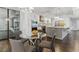 This kitchen area offers stainless steel appliances, pendant lighting, bar seating, and view to a living space at 13 Dovetail Cir, Henderson, NV 89014