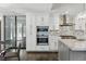 This kitchen offers built in ovens, stainless steel appliances, and a view through the large glass enclosed patio at 13 Dovetail Cir, Henderson, NV 89014