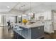 Open kitchen area featuring granite countertops, stainless steel appliances, bar stool seating, and modern pendant lighting at 13 Dovetail Cir, Henderson, NV 89014