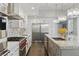 Bright kitchen boasts stainless steel appliances, granite countertops, a gas range, and stylish modern pendant lighting at 13 Dovetail Cir, Henderson, NV 89014