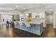 Large kitchen with stainless appliances, granite countertops, bar stool seating, and modern pendant lighting throughout the space at 13 Dovetail Cir, Henderson, NV 89014