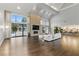 Bright living room featuring a fireplace, hardwood floors, modern furnishings, and access to the pool at 13 Dovetail Cir, Henderson, NV 89014