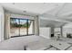 Bright living room with sliding glass doors to a balcony, and an open floorplan at 13 Dovetail Cir, Henderson, NV 89014