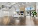 Bright living room featuring high ceilings, stone fireplace, and sliding doors to the outdoor space at 13 Dovetail Cir, Henderson, NV 89014
