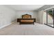 Spacious main bedroom boasts neutral carpeting and a sliding glass door for plenty of natural light at 13 Dovetail Cir, Henderson, NV 89014