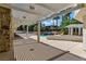 Spacious covered patio with pergola offering a glimpse of the pool and lush landscaping at 13 Dovetail Cir, Henderson, NV 89014
