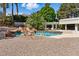 Resort style pool with rock waterfall, pergola, and desert landscaping at 13 Dovetail Cir, Henderson, NV 89014